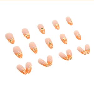 Cute almond shape press-on nails with orange patchwork and yellow smiley face design
