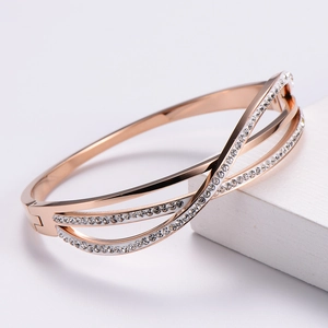 Detail of rose gold crisscross bracelet featuring double row pavé zircon inlay crystals