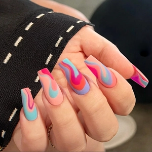 Close-up of matte long square press-on nails with multi-color wave patterns