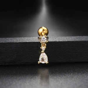Macro view of a gold screw ball earring with clear round and teardrop zircons