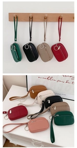 Collection of mini PU leather coin purses in various colors with wrist straps and keychains