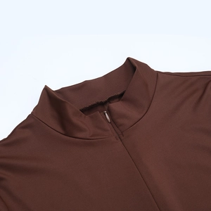 Detail of the high collar with half-zipper closure on a brown slim fit jumpsuit