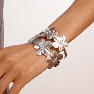 Close-up of double-layer silver flower cuff bracelet with brushed metal texture