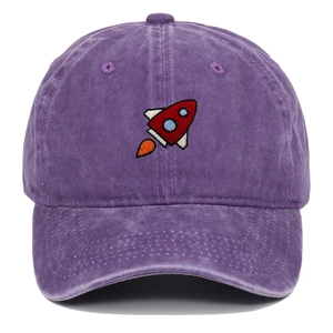 Detailed close-up of premium purple washed cotton baseball cap with rocket embroidery