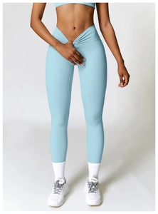 Detailed view of high-waisted yoga leggings with V-shaped cross waist and front pleats