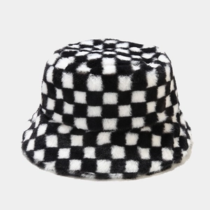 Detailed view of the black and white checkerboard plush faux fur bucket hat texture
