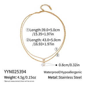 Detail of double-layered waterproof stainless steel necklace with pearl and zircon charms
