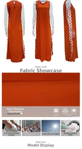 Detail of orange sleeveless midi dress showing white scalloped lace trim and side slit