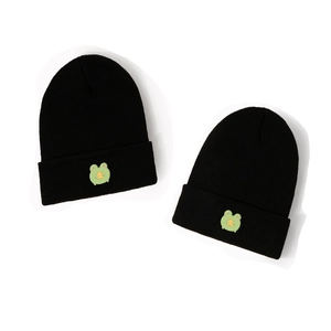 Pair of black knit beanies with green cartoon frog embroidery in a minimalist design