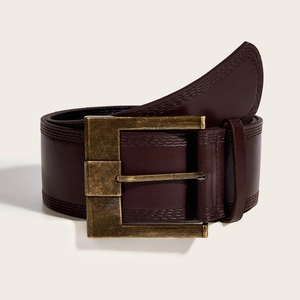 Close-up of a wide dark brown leather belt with large vintage bronze square buckle