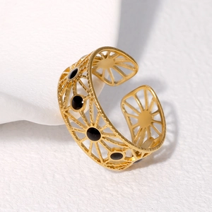 Adjustable golden stainless steel ring featuring hollow sunburst and black dots