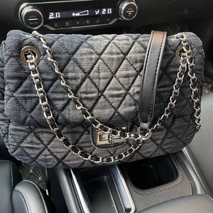 Deep grey denim hobo bag with diamond quilted patterns and silver chain shoulder strap