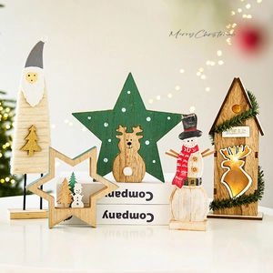 Handcrafted wooden Christmas tree ornaments featuring reindeer and Santa on a white stand