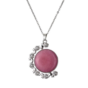 Close-up of pink round gemstone pendant with silver star and moon diamond frame