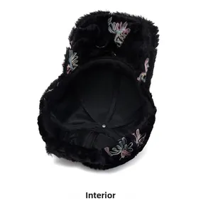 Detailed view of the warm interior lining and stitching of the black plush floral hat