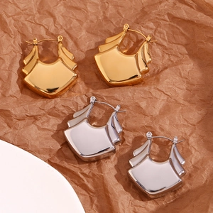 Detailed close-up of layered fan-shaped earrings in gold and silver stainless steel
