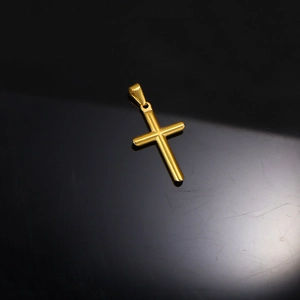 Polished 24k gold plated stainless steel cross pendant on black reflective surface