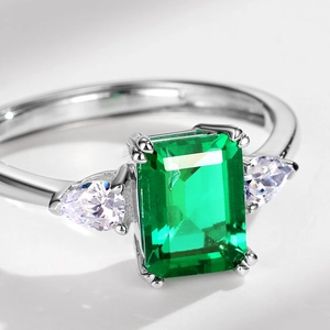 S925 silver ring featuring a square emerald-cut green gemstone with pear-shaped side stones