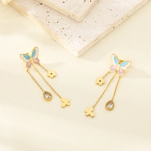 Detail of gold butterfly tassel earrings with blue pink enamel and teardrop gemstone
