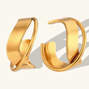 Detailed view of irregular 18K gold plated hoop earrings with sleek twisted metal texture