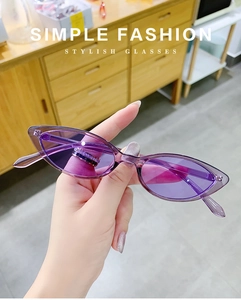 Close-up of vintage purple cat-eye sunglasses with translucent frames and light lenses