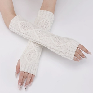 Detail of white diamond-pattern knit arm warmers showing texture and ribbed cuffs