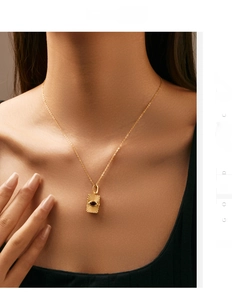 Detail of S925 silver gold-plated envelope necklace with sunburst sun eye pendant