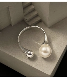 Detail view of S925 sterling silver open ring with a round pearl and silver bead detail