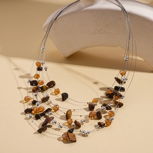 Detail of bohemian multilayer beaded necklace with tiger eye stone and silver accents