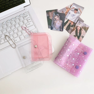 Detail of purple glitter PVC photocard holder with button closure and ball chain straps