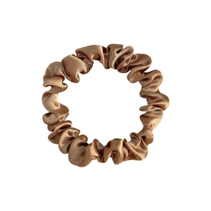 Champagne gold satin scrunchie with silky pleated texture and elastic hair tie design