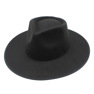Detailed close-up of the smooth black wool fedora brim and structured pinch crown top