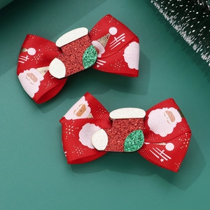 Detail of red grosgrain ribbon bow hair clips with glittery Christmas stocking charm