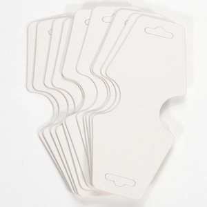 Stack of white paper display cards with pre-cut holes for jewelry and accessory hanging