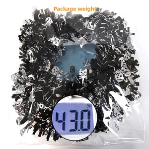 Detailed view of 2M Halloween tinsel garland with skull motifs on a weighing scale