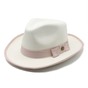 Detail of white wool fedora with pink ribbon, side bow and bronze buckle decoration