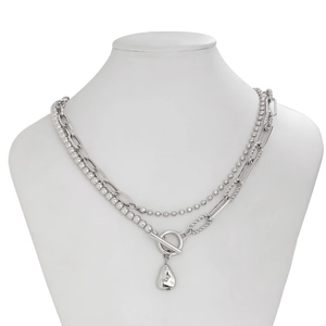 Detail of silver double layered chain necklace with T-bar toggle clasp and liquid pendant