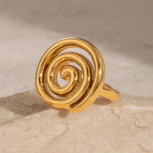 Elegant 18k gold-plated stainless steel spiral ring on natural stone background