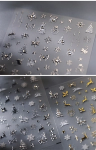 Macro view of 5D embossed Christmas nail stickers with gold and silver snowflake patterns