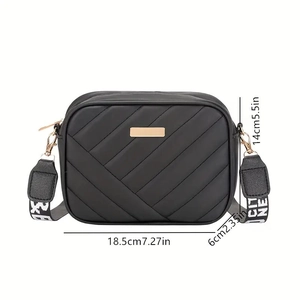 Black quilted crossbody camera bag with adjustable wide strap and dimensions display
