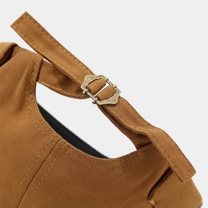 Detail of adjustable metal buckle and canvas strap on a brown docker brimless hat
