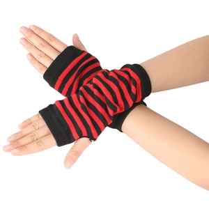 Close-up of red and black striped knitted arm warmers with thumb holes in a cross pose