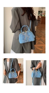 Chic blue snakeskin shell bag with gold hardware and top handle shown on a model