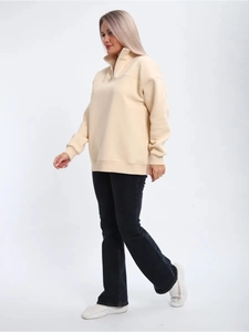 Detail view of women's beige half-zip sweatshirt with stand collar and loose sports fit