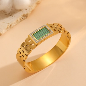Detail of 18K gold-plated bangle featuring a malachite rectangle and zircon accents