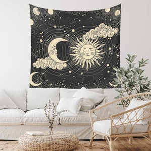 Detailed view of sun and moon tapestry hanging above a sofa in a modern living room