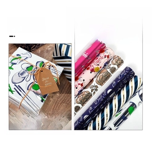 Assorted holiday gift wrapping paper rolls featuring floral and Father's Day patterns