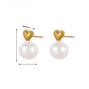 Detail view of gold heart stud earrings with white pearls and size measurements