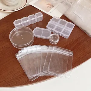 Transparent portable jewelry storage kit with PP boxes and clear pouches on wooden table