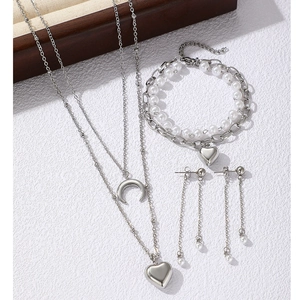 Silver jewelry set with layered moon heart necklace, pearl bracelet, and drop earrings